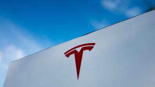 Close-up of Tesla Motors logo against a bright blue sky in Pleasanton, California, July 23, 2018. 