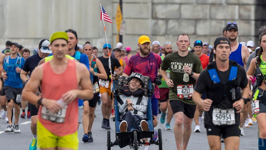 From 2023: Matthew Burdette pushes Kevin Dilegge during the Marine Corps Marathon.