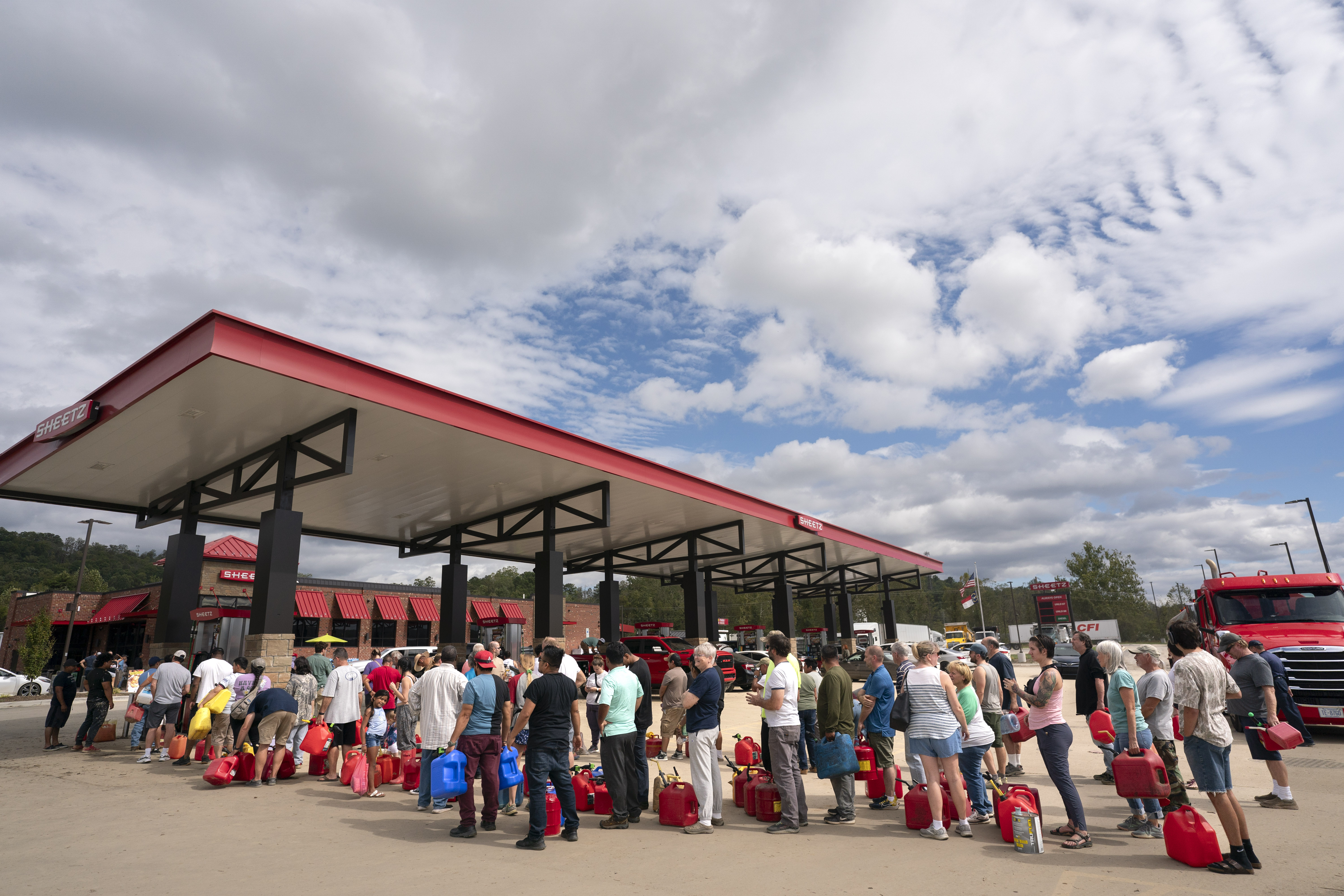 People wait in line for gasoline in the aftermath of Hurricane Helene on September 29, 2024 in Fletcher, North Carolina.