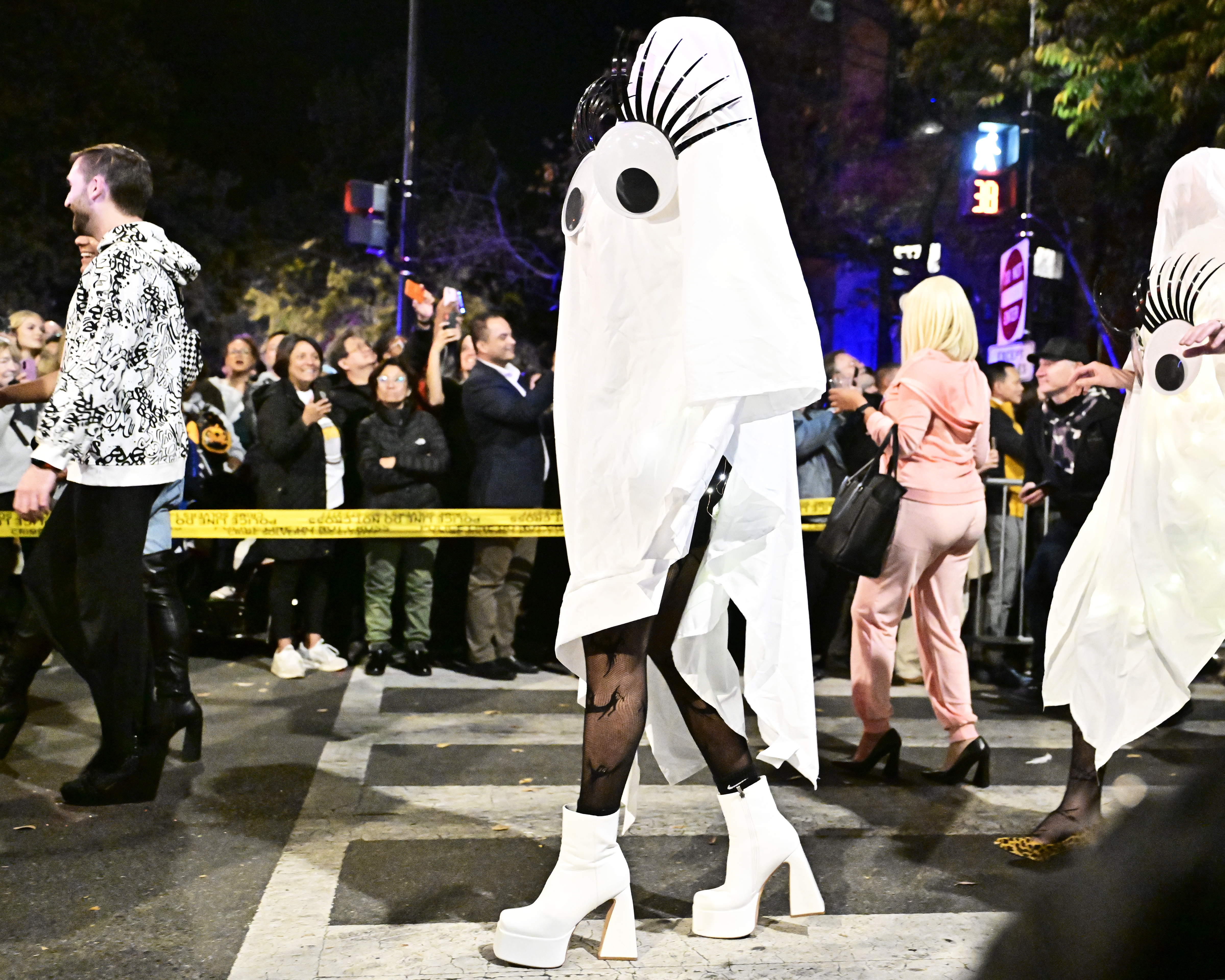 WASHINGTON, DC – OCTOBER 29: A runner wears a ghost with eyelashes costume with white platform ankle boo at the annual 17th Street High Heel Race on October 29, 2024 in Washington, DC. (Photo by Shannon Finney/Getty Images)