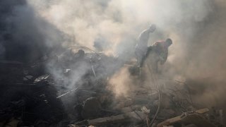 Rescue workers search for victims at the site of Thursday’s Israeli airstrike in Beirut, Lebanon, Friday, Oct. 11, 2024. (AP Photo/Hassan Ammar)