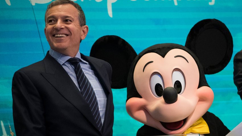 (L to R) Chief executive officer and chairman of The Walt Disney Company Bob Iger and Mickey Mouse look on before ringing the opening bell at the New York Stock Exchange (NYSE), November 27, 2017 in New York City.