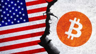 Bitcoin and USA flag on a cracked wall.