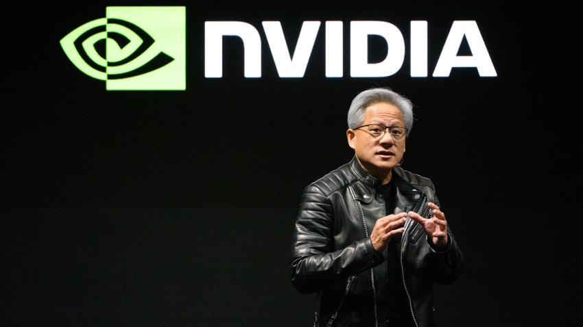 Jensen Huang, co-founder and chief executive officer of Nvidia Corp., holds up the company’s AI accelerator chips for data centers as he speaks during the Nvidia AI Summit Japan in Tokyo, Japan, on Wednesday, Nov. 13, 2024. 