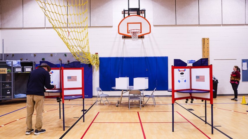 File – A voter casts their ballot at a polling station in Randolph Elementary School in Arlington, Virginia, US, on Tuesday, March 5, 2024.