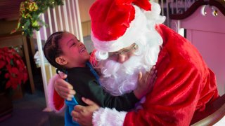 Malik Gunter, 5, tugs at Santa's beard at Faith Moravian Church