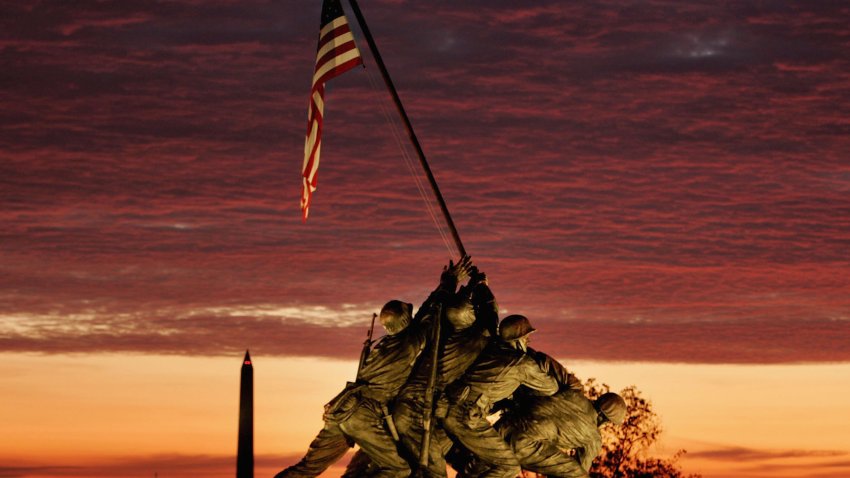 WASHINGTON – NOVEMBER 11: The early morning sun begins to rise behind the Iwo Jima Memorial on November 11, 2004 in Arlington, Virginia. The 17th annual Veterans Day Parade along with many other Veterans Day events will take place in the Washington area today as part of an international day of rememberance to those who have died during military conflicts. (Photo by Mark Wilson/Getty Images)