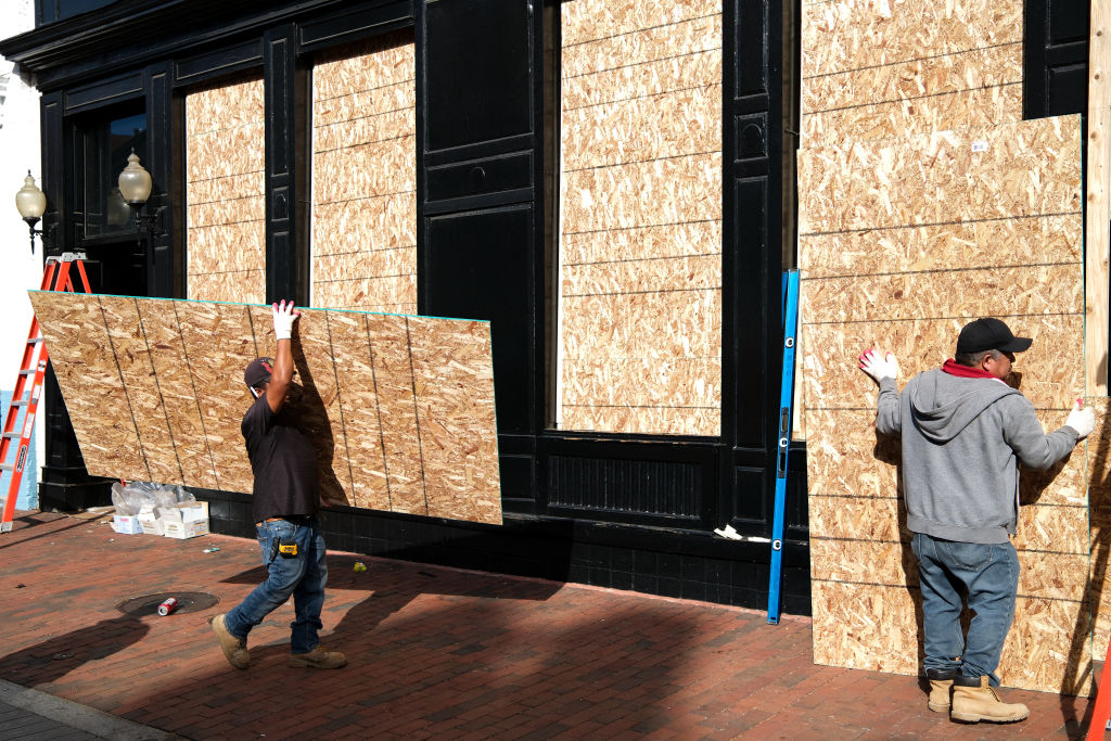 Workers board up a store near the White House on Election Day in Washington, DC, November 5, 2024. (Photo by Charly TRIBALLEAU / AFP) (Photo by CHARLY TRIBALLEAU/AFP via Getty Images)