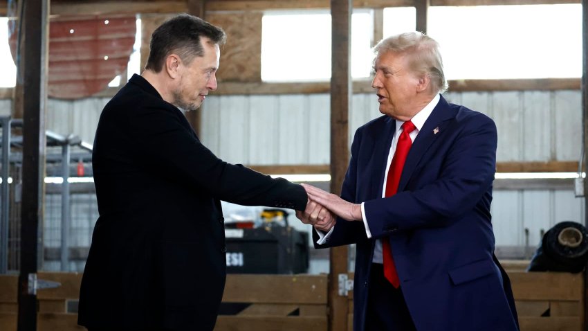 Elon Musk (L) shakes hands with Republican presidential nominee, former President Donald Trump back stage during a campaign rally at the Butler Farm Show grounds on October 05, 2024 in Butler, Pennsylvania. 