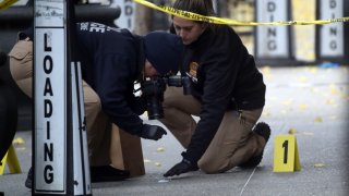 Police place bullet casing markers outside of a Hilton Hotel in Midtown Manhattan where United Healthcare CEO Brian Thompson was fatally shot on December 04, 2024 in New York City. 