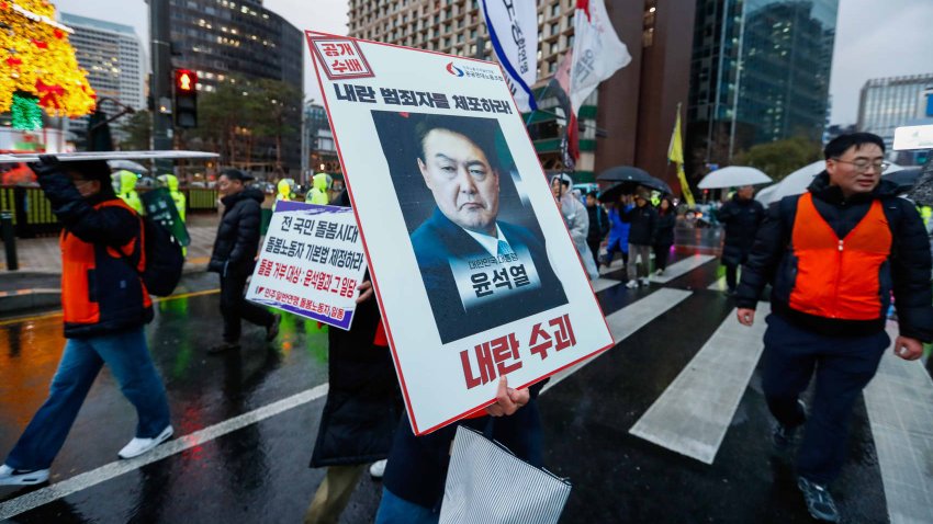 People march in heavy rain to protest against South Korean president Yoon Suk Yeol, as strike and protests continue amid the martial law crisis, in Seoul, South Korea, on December 05, 2024. 