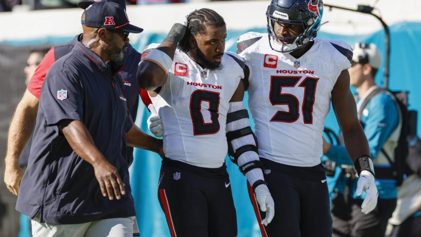 Houston Texans linebacker Azeez Al-Shaair (0) is escorted off the field