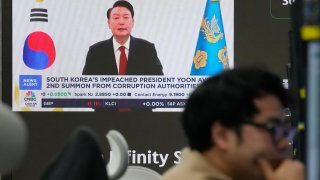 A TV screen shows a file image of South Korean President Yoon Suk Yeol