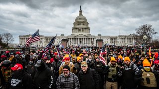 FILE -- Pro-Trump protesters, including Proud Boys leader Joe Biggs, (plaid shirt at bottom center of frame), gather in front of the U.S. Capitol Building on Jan. 6, 2021, in Washington, D.C.