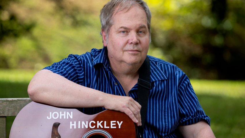 John Hinckley Jr. sits for a portrait with his guitar in Williamsburg, Virginia, on September 14, 2022. – More than four decades after John Hinckley shot Ronald Reagan, the man who was acquitted of the crime on an insanity defense and subsequently hospitalized for 34 years is fully free.
But the one thing he wants most after decades of treatments and years of conditional release still eludes him: a guitarist and songwriter, Hinckley longs to play a live concert. (Photo by Ryan M. Kelly / AFP) (Photo by RYAN M. KELLY/AFP via Getty Images)