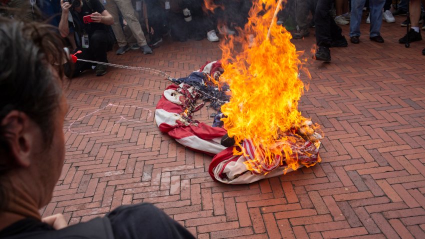 WASHINGTON, DISTRICT OF COLUMBIA, UNITED STATES – 2024/07/24: Pro-Palestinian demonstrators burn a US flag at Union Station during a protest against Israeli Prime Minister Benjamin Netanyahu’s visit to the USA. Activists staged multiple protests near the Capitol to protest Netanyahu’s visit to Washington amid Israel’s ongoing war against Hamas in Gaza. (Photo by Probal Rashid/LightRocket via Getty Images)