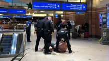 Phoenix police arrest a man on Dec. 25, 2024, who police said arrived at Sky Harbor with guns after he received a text falsely reporting an active shooter at the airport. An unrelated shooting did occur at the airport earlier that night, leaving four people hurt.