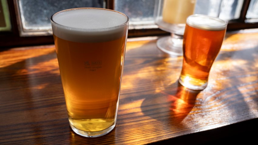 Pint and a half of English ale on a pub table