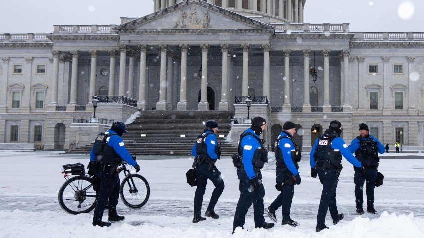 U.S. Capitol Police officers walk through the snow outside the U.S. Capitol