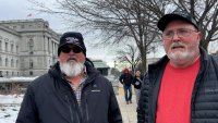 Two men in front of buildings in Washington, D.C.