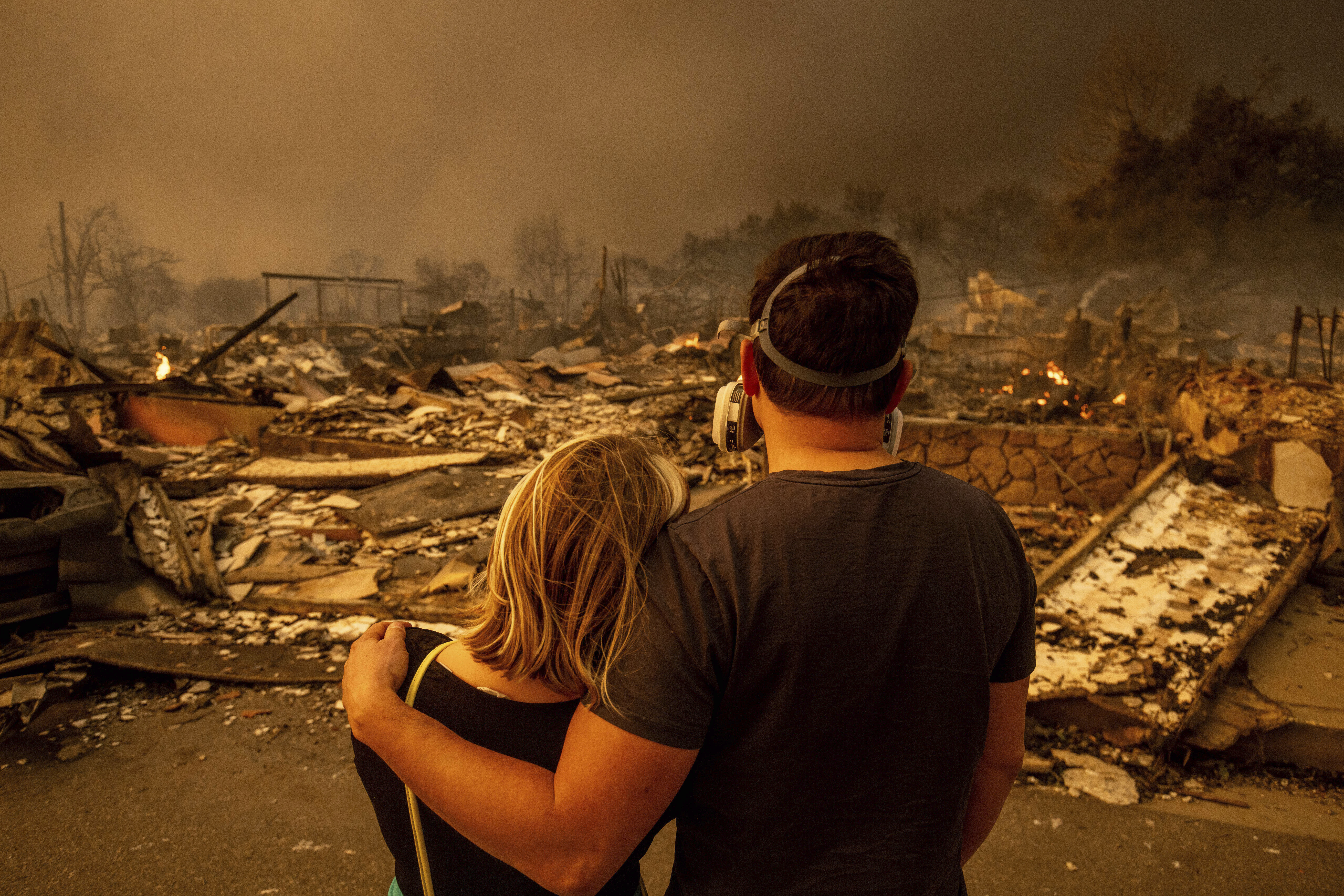 Megan Mantia, left, and her boyfriend Thomas, only first game given, return to Mantia’s fire-damaged home after the Eaton Fire swept through the area, Wednesday, Jan. 8, 2025, in Altadena, Calif.