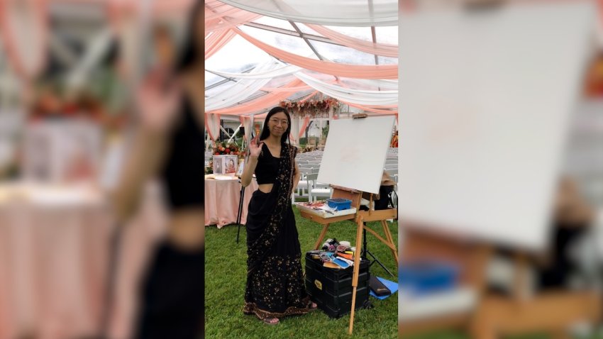 Kim-Vi Tran by a canvas