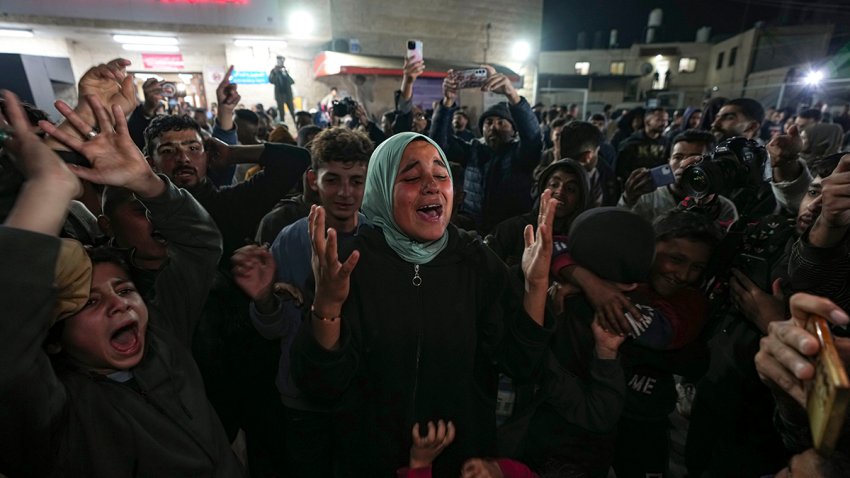 Palestinians celebrate the announcement of a ceasefire deal between Hamas and Israel in Deir al-Balah, central Gaza Strip, Wednesday, Jan. 15, 2025.