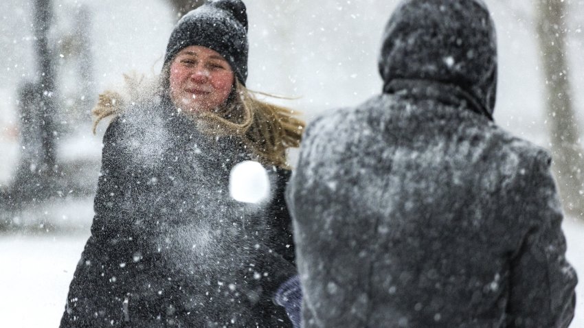 A visitor throws a snowball next to the U.S. Capitol building during a winter storm in Washington, D.C., U.S., on Sunday, Jan. 16, 2022. Washington may get an inch of snow before rain starts to fall late tonight after a fast-moving winter storm knocked out power to thousands across the U.S. South and canceled and delayed flights. Photographer: Samuel Corum/Bloomberg via Getty Images