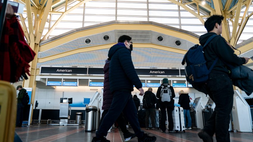 Travelers near the American Airlines baggage check-in area at Ronald Reagan National Airport (DCA) in Arlington, Virginia, US, on Tuesday, Jan. 7, 2025. A winter storm grounded flights across the eastern and central US on Monday, shutting federal offices in Washington and knocking out power across six states. Photographer: Al Drago/Bloomberg via Getty Images