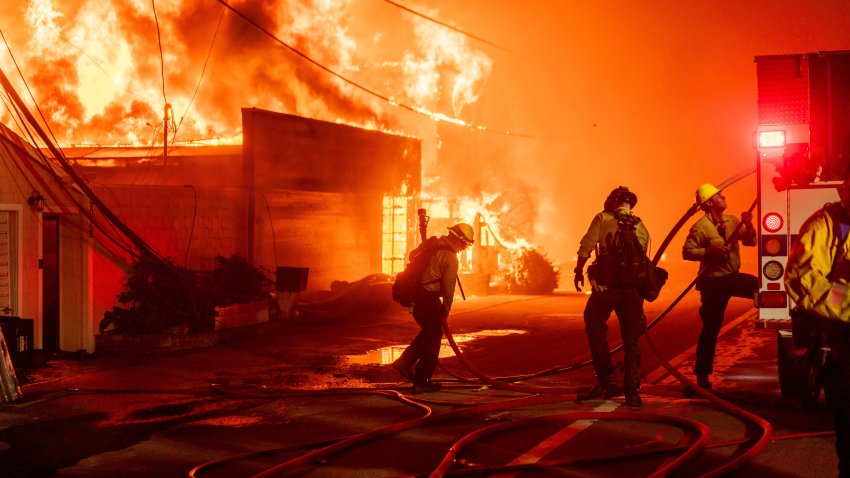 Firefighters battle flames during the Palisades Fire in the Pacific Palisades neighborhood of Los Angeles, California, US, on Tuesday, Jan. 7, 2025. A fast-moving wildfire ripped through an affluent neighborhood in Los Angeles, forcing thousands of people to evacuate as the region braced for a brutal wind storm that could last well into the weekend. Photographer: Kyle Grillot/Bloomberg via Getty Images