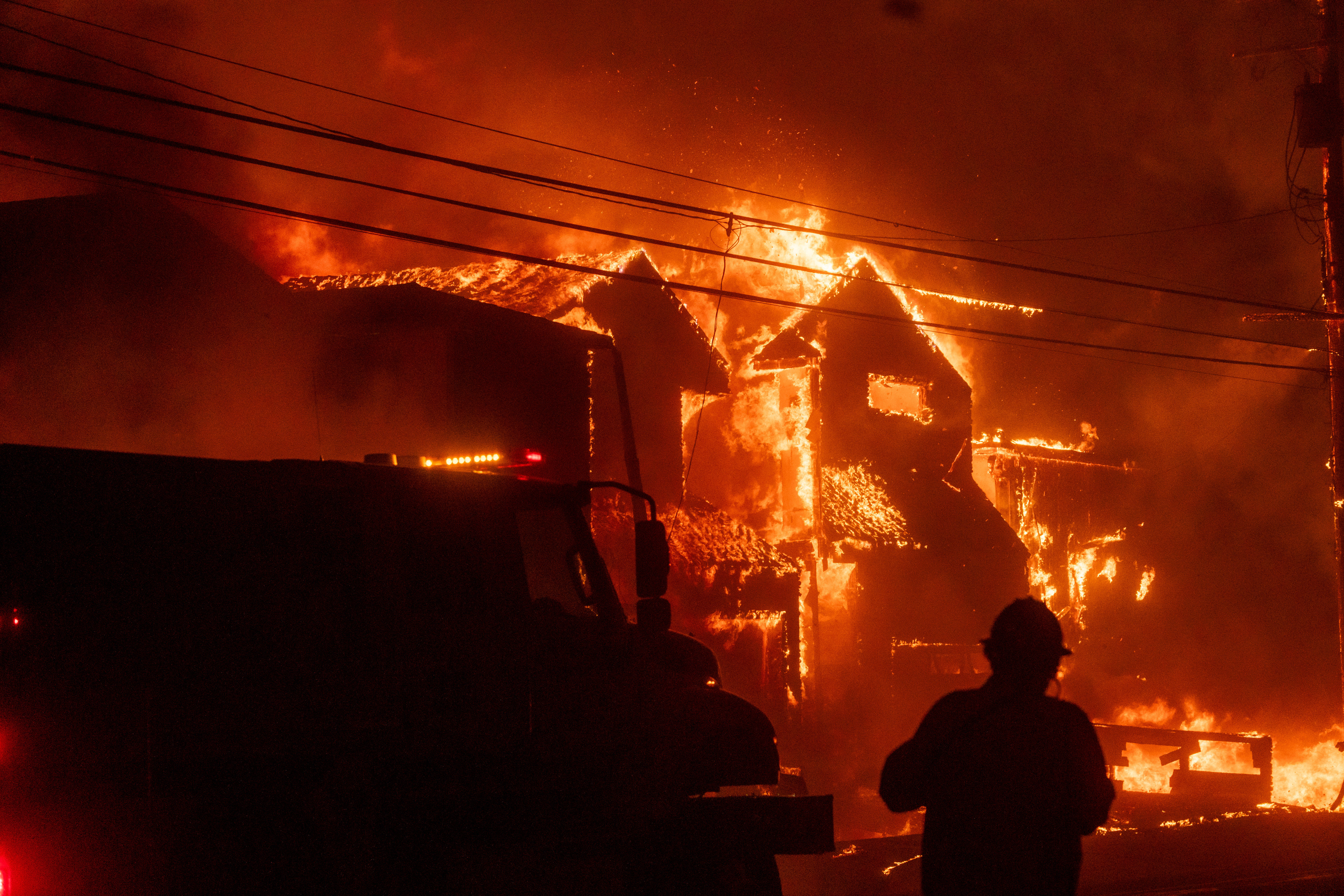 A firefighter in front of a burning structure during the Palisades Fire in the Pacific Palisades neighborhood on Jan. 7, 2025.