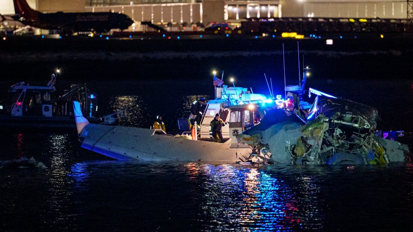 ARLINGTON, VIRGINIA – JANUARY 30: (EDITORS NOTE: Image contains graphic content) Emergency response units assess airplane wreckage in the Potomac River near Ronald Reagan Washington Airport on January 30, 2025 in Arlington, Virginia. An American Airlines flight from Wichita, Kansas collided with a helicopter while approaching Ronald Reagan National Airport. (Photo by Andrew Harnik/Getty Images)