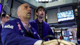 Specialist traders work inside a post on the floor at the New York Stock Exchange.