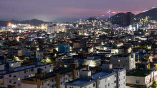 Illuminated residential buildings and houses at dusk in Mokpo, South Korea, on Friday, Aug. 16, 2024.