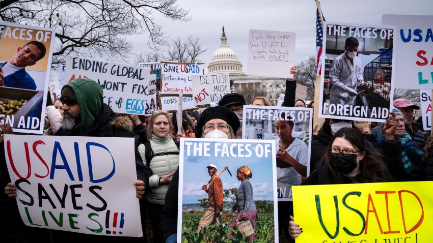 Demonstrators and lawmakers rally against President Donald Trump and his ally Elon Musk as they disrupt the federal government, including dismantling the U.S. Agency for International Development, which administers foreign aid approved by Congress, on Capitol Hill in Washington, Wednesday, Feb. 5, 2025.