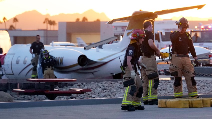 File. Firefighters work around the site of a crashed Learjet at Scottsdale Airport after it collided with a parked plane Monday, Feb. 10, 2025, in Scottsdale, Ariz.