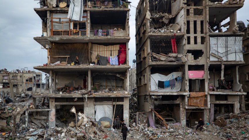 Palestinians sit in their partially standing homes, covered with sheets as makeshift walls, in an area largely destroyed by the Israeli army’s air and ground offensive in Jabaliya, Gaza Strip, Tuesday, Feb. 11, 2025.