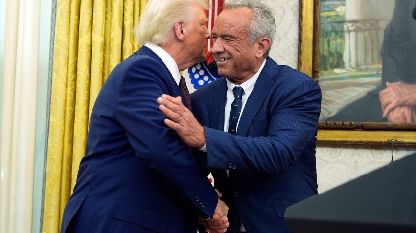 President Donald Trump congratulates Robert F. Kennedy Jr., after he was sworn in as Health and Human Services Secretary in the Oval Office at the White House, Thursday, Feb. 13, 2025, in Washington.