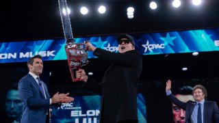 Elon Musk, left, receives a chainsaw from Argentina's President Javier Milei, right, as they arrive speaks at the Conservative Political Action Conference, CPAC, at the Gaylord National Resort & Convention Center, Thursday, Feb. 20, 2025, in Oxon Hill, Md.