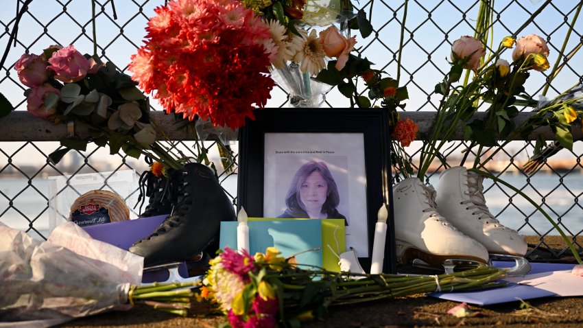 WASHINGTON, DC – FEBRUARY 4: A Memorial with a photo of coach Inna Volyanskaya as a centerpiece, is set up on a fence overlooking the Potomac River at Haines Point honoring the local skaters and the flight crew that died when their airliner collided with a military helicopter just before landing at Reagan National Airport on the night of January 29th. Photos made in Washington, DC on February 4, 2025. (Photo by John McDonnell/ for The Washington Post via Getty Images)