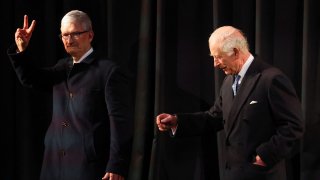 Britain’s King Charles and CEO of Apple, Tim Cook walk at Apple’s UK Head Office at Battersea Power Station in London, Britain, December 12, 2024.
