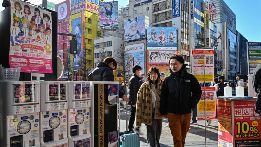 TOPSHOT – Customers enter an electronics shop in the Akihabara district of Tokyo on January 12, 2024. 