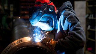 FILE PHOTO: A worker welds a steel tube at HCC, a company that uses parts to make combines, at the factory in Mendota, Illinois, U.S., February 21, 2025. 