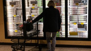 A shopper looks at eggs for sale in a grocery store in the Manhattan borough of New York City, Feb. 25, 2025.