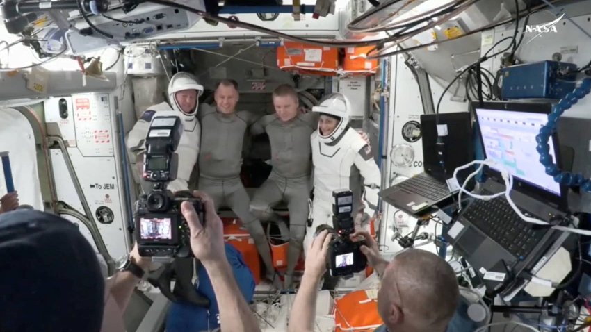 NASA astronaut Butch Wilmore, Roscosmos cosmonaut Aleksandr Gorbunov and NASA astronauts Nick Hague and Suni Williams pose for a photo at the hatch a SpaceX Crew Dragon capsule before closing the hatch in preparation for undocking from the ISS to begin their return to Earth March 17, 2025 in this still image taken from video. 