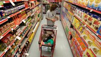 A woman looks at products in the aisle of a store