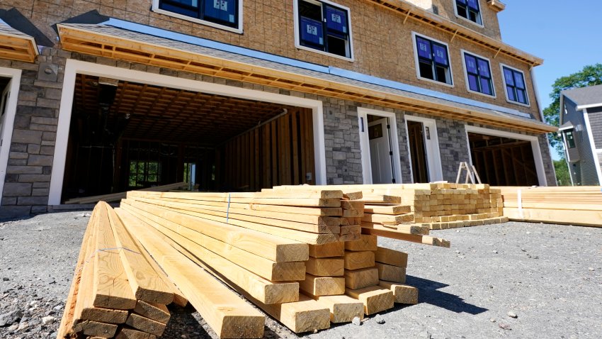 Lumber is piled at a housing construction site, Thursday, June 24, 2021, in Middleton, Mass.