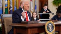 President Donald Trump holds the pen he will use to sign an executive order in the East Room of the White House in Washington, Thursday, March 20, 2025.