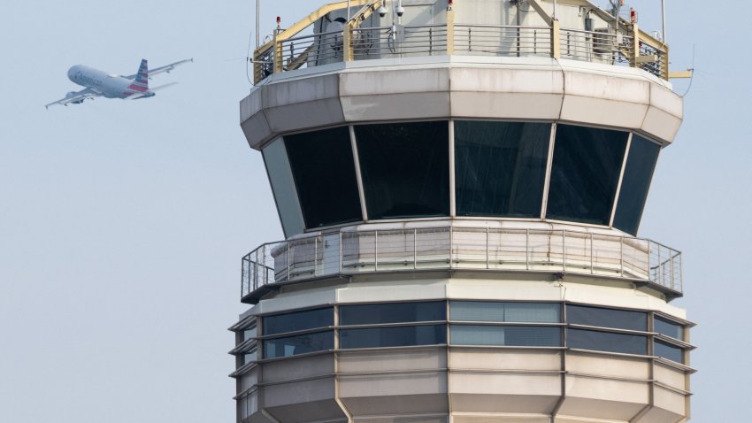 An American Airlines Airbus A319 airplane takes off past the air traffic control tower at Ronald Reagan Washington National Airport in Arlington, Virginia, January 11, 2023.