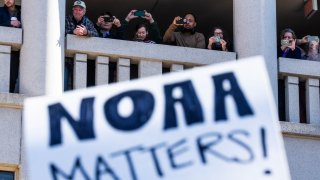 UNITED STATES – MARCH 3: National Oceanic and Atmospheric Administration workers watch a rally outside headquarters to oppose the recent firings, in Sliver Spring, Md., on Monday, March 3, 2025. Sen. Chris Van Hollen, D-Md., and other members of Congress also attended.